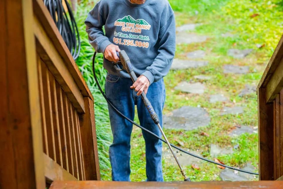 Dave pressure washing a wooden deck